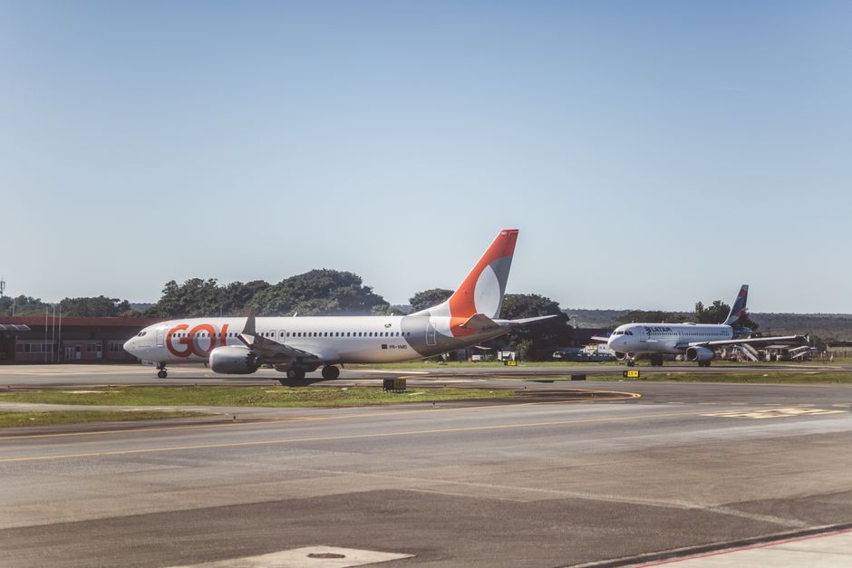 Airliners taxiing on a sunny day at an airport, ready for takeoff.